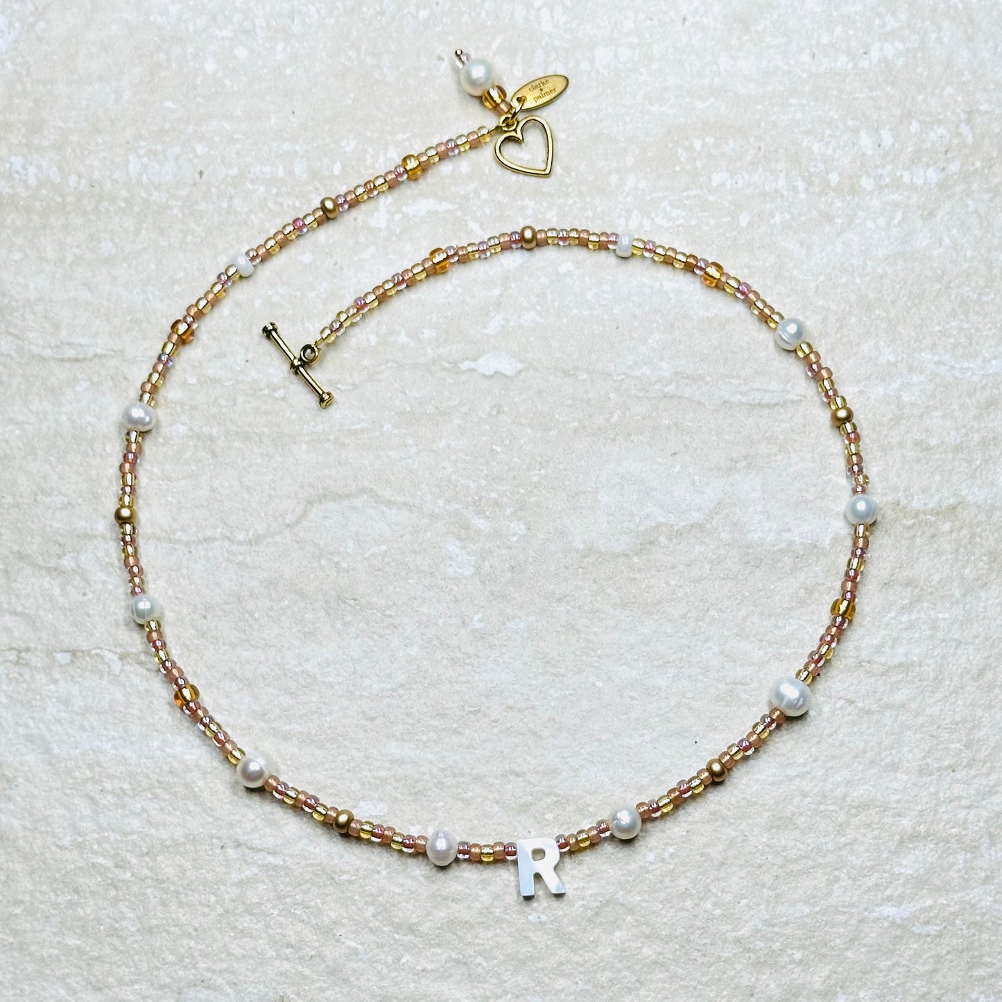 Rosy Glow Pearl Letter Necklace