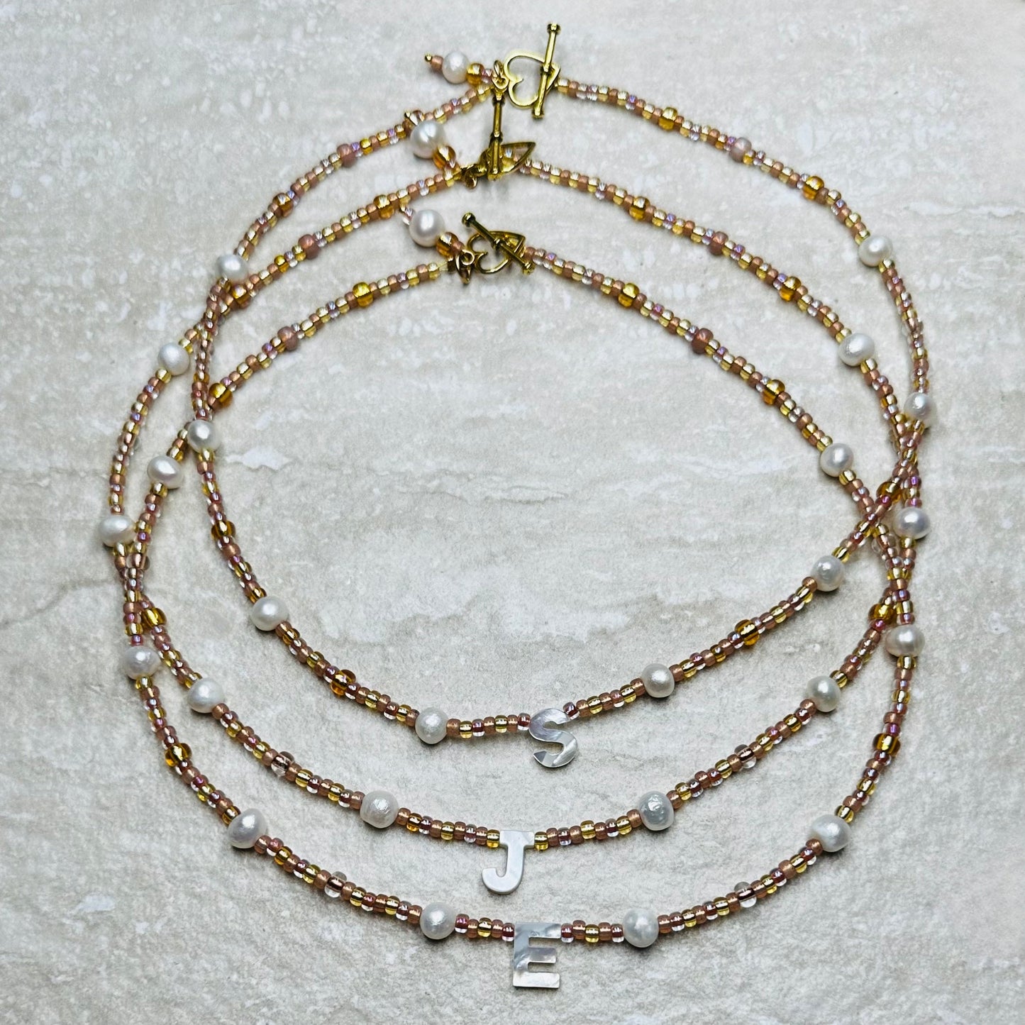 Rosy Glow Pearl Letter Necklace