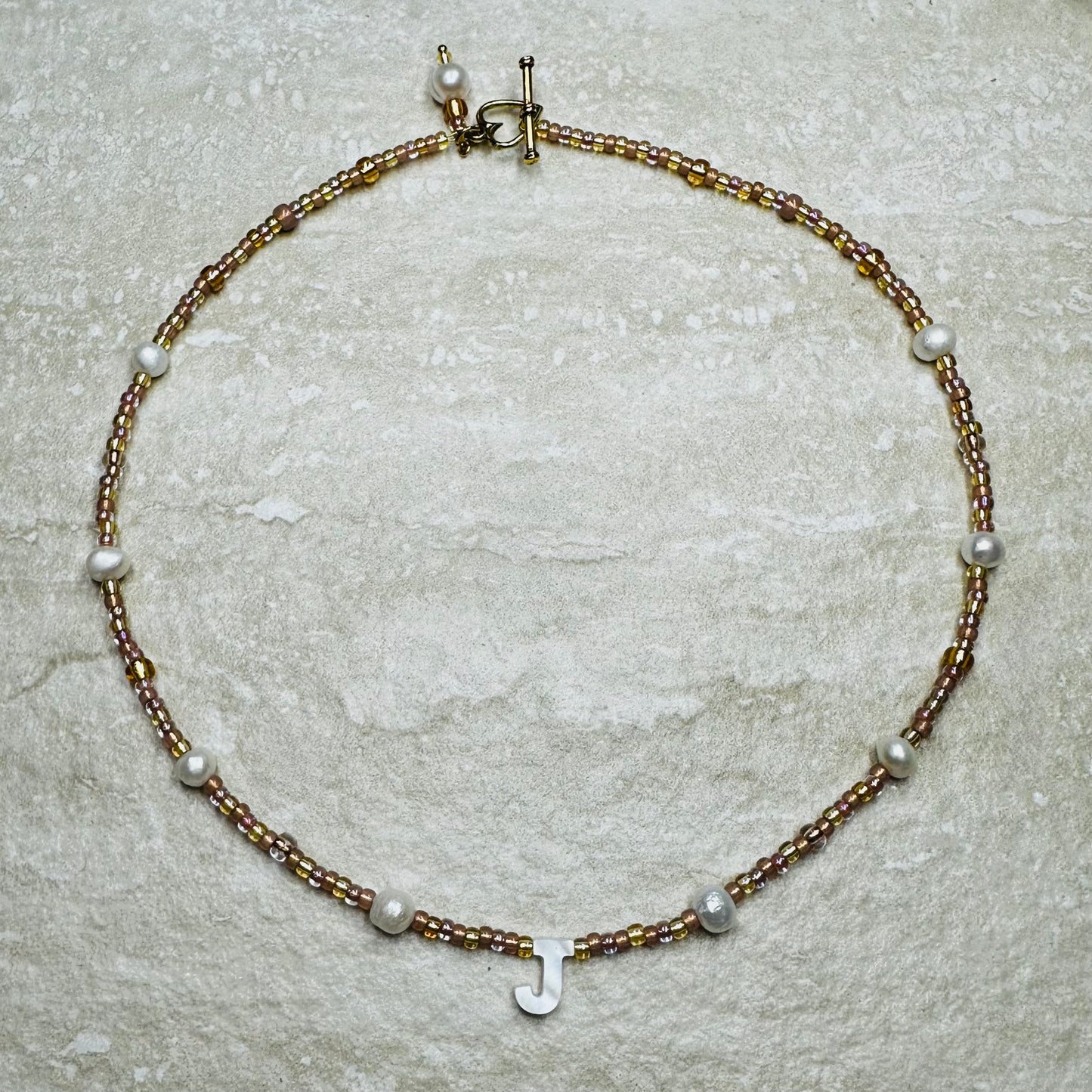 Rosy Glow Pearl Letter Necklace