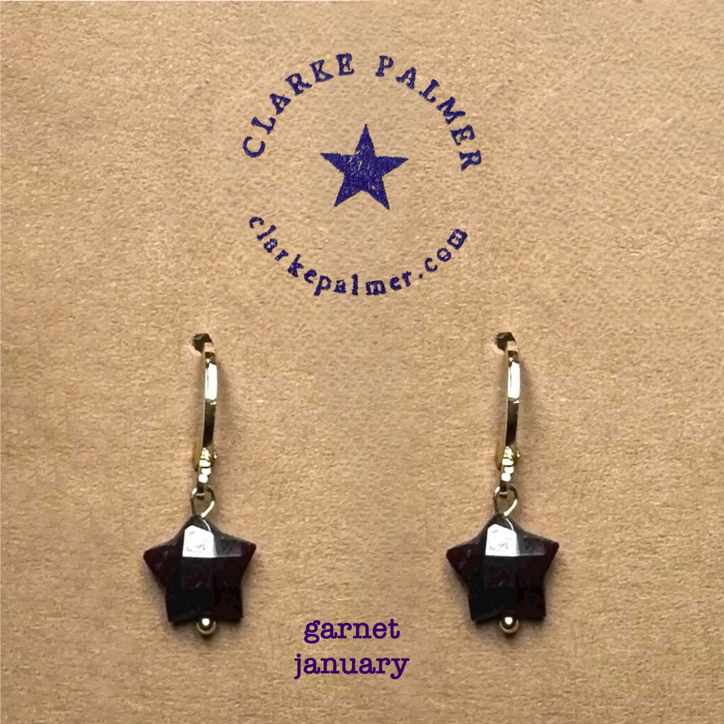 Clarke Palmer Garnet Star January Birthstone earrings On neutral background 