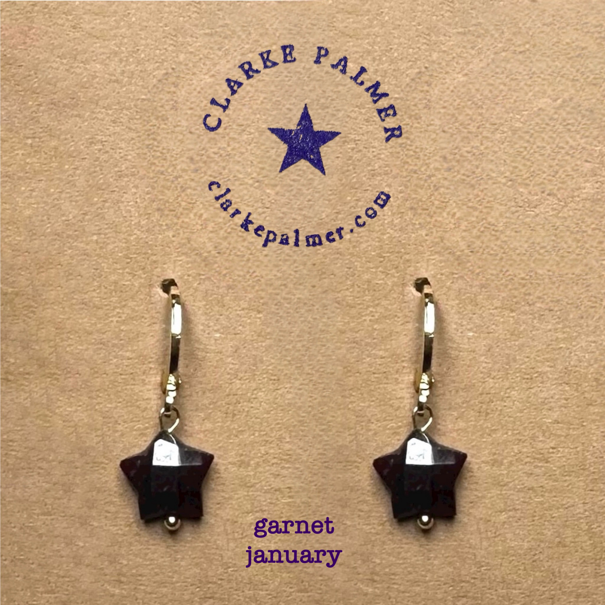 Clarke Palmer Garnet Star January Birthstone earrings On neutral background 