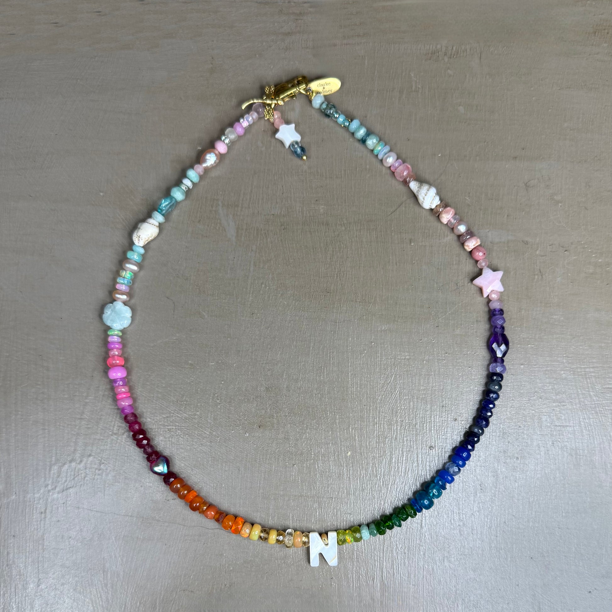 Multicolored gemstone beaded necklace on a gray surface