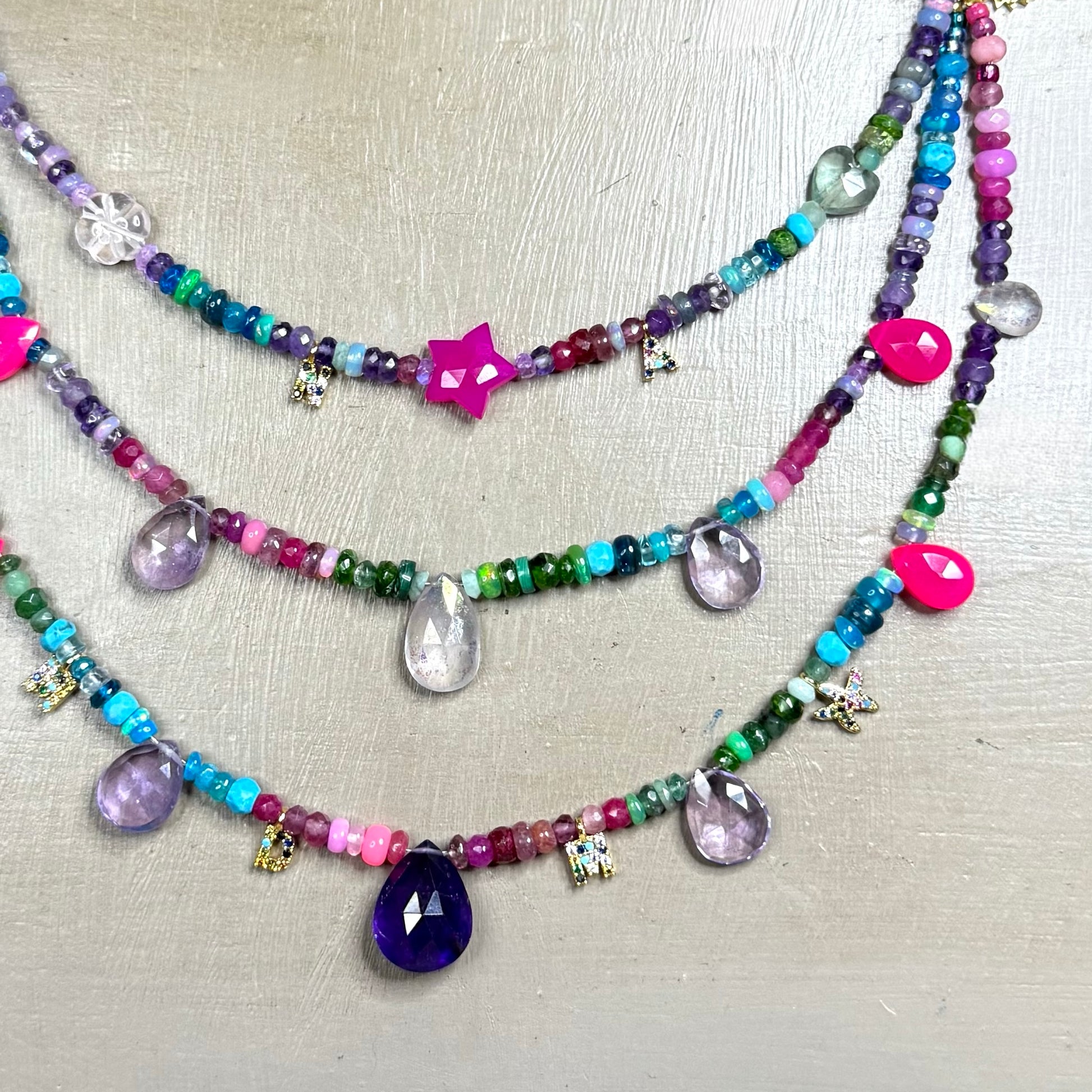 Close_up_Personalised_Three-Layer_Gemstone_Necklace_with_22kt_Gold_Vermeil_Letter_Charms_Tropical_Punk_CLARKE_PALMER