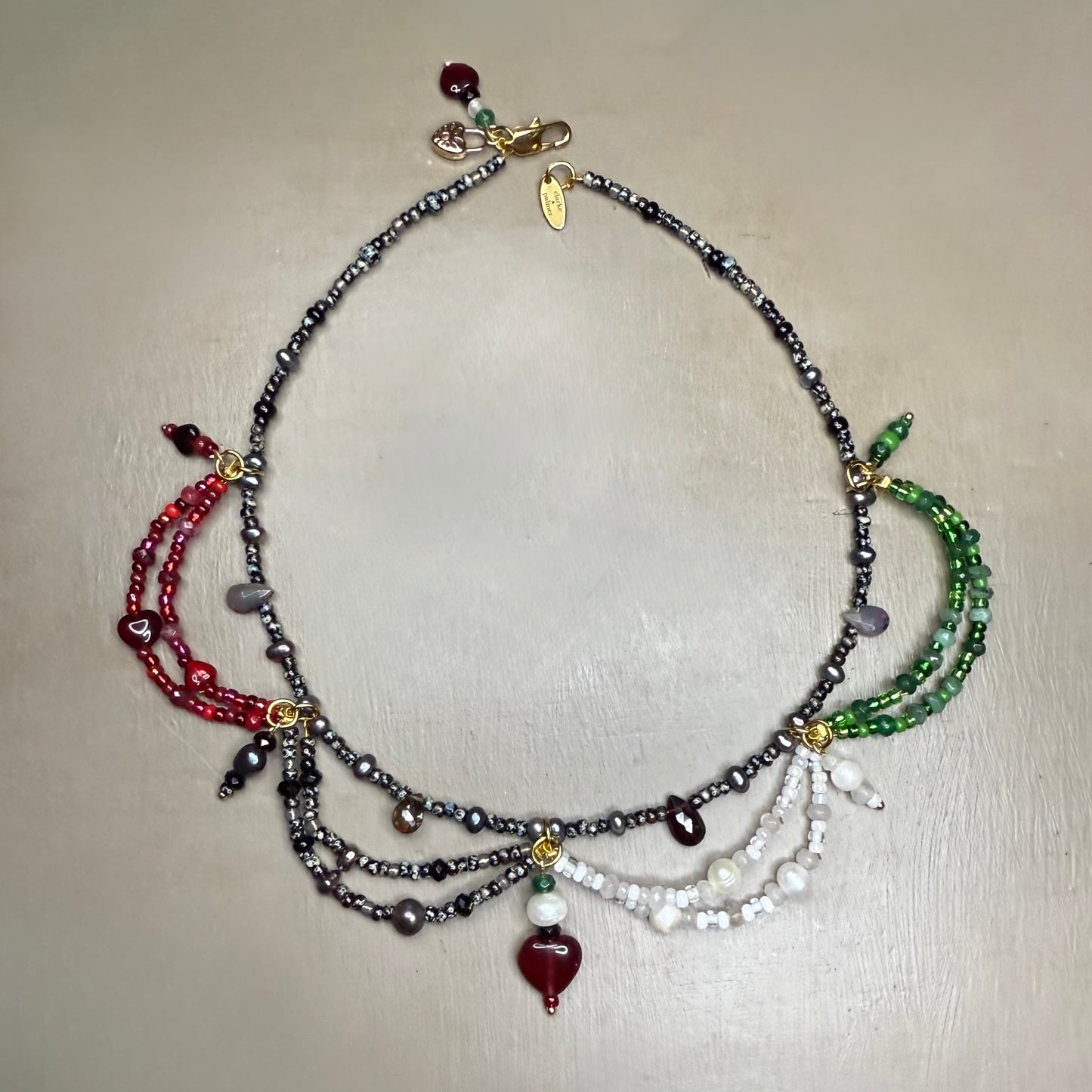 Multistrand beaded necklace with colorful gemstone beads on a light background