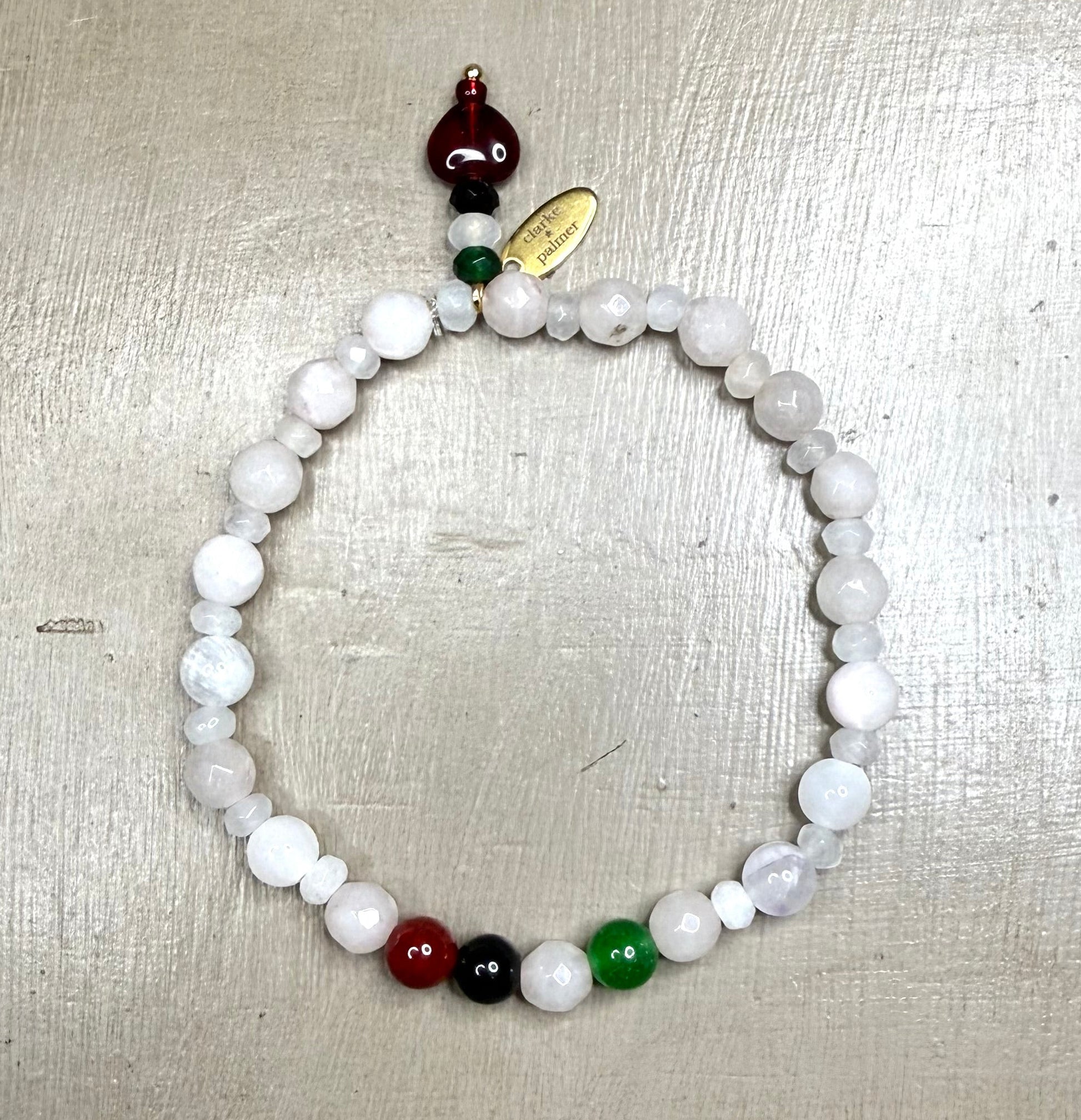 Beaded bracelet with colored gemstone beads on a metallic surface