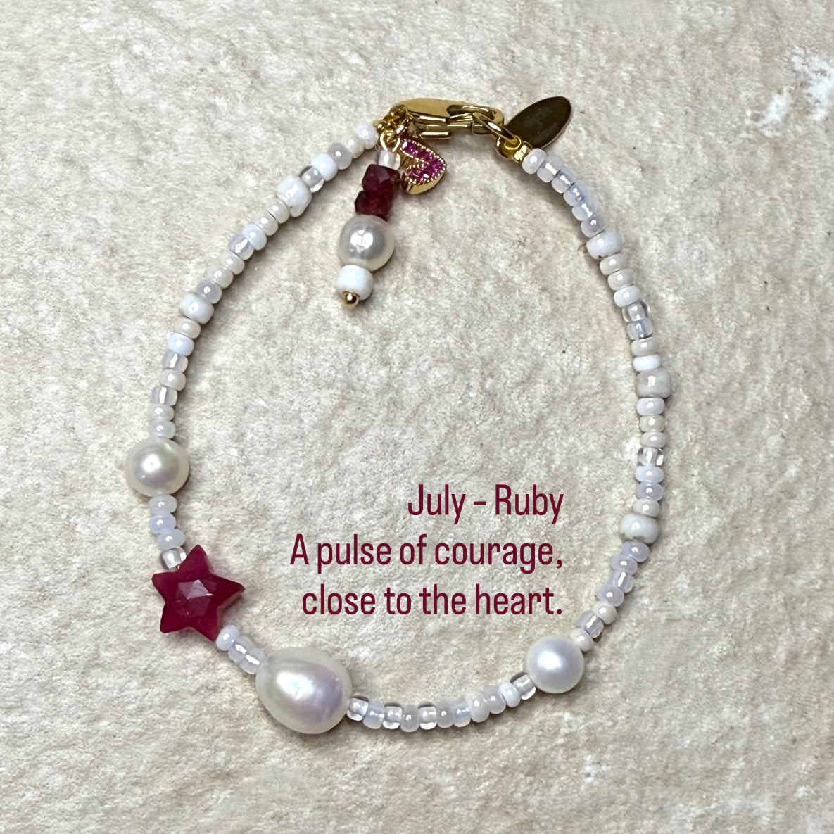 Pearl & Ruby Star Birthstone Bracelet  with quote: July – Ruby
A pulse of courage, close to the heart.
