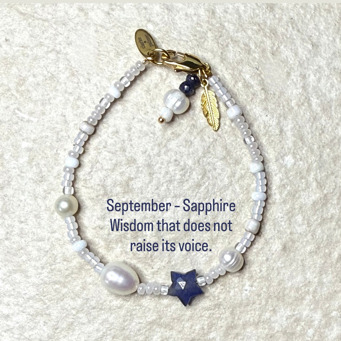Pearl & Sapphire Star Birthstone Bracelet with quote September – Sapphire
Wisdom that does not raise its voice.